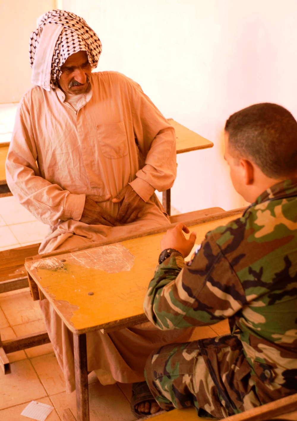 Iraqi Man Receives Medical Care from Salvadoran Soldier in Byda Village
