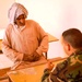 Iraqi Man Receives Medical Care from Salvadoran Soldier in Byda Village