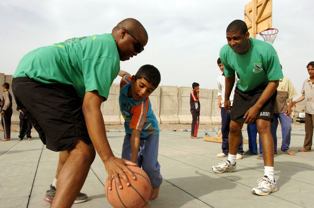 Soldiers Teach Iraqi Children Basketball Skills at Camp