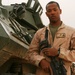 Marine Corps Cpl. Oquendo Stands Beside Light Armored Vehicle in Iraq