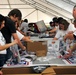 Volunteers Pack Thousands of Care Packages for Troops at USO Event