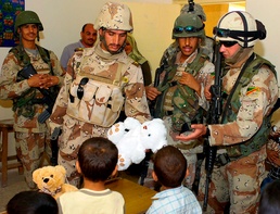 Iraqi Soldiers Hand Out Toys to Children in Sab Al Bour
