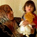 Iraqi Child Clutches New Doll Received from U.S. and Iraqi Soldiers