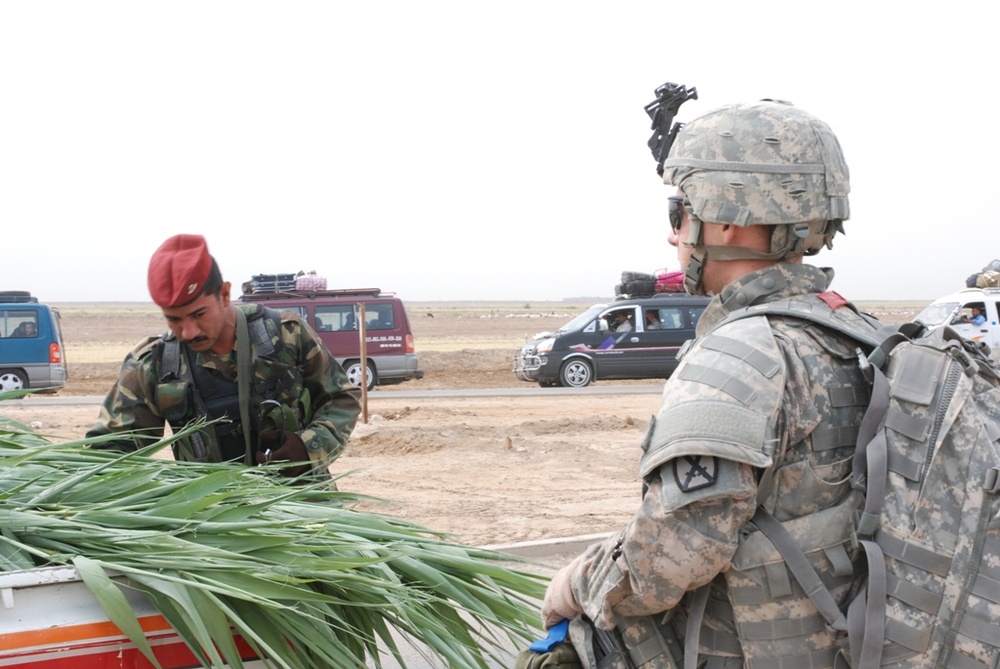 Medic Observes Iraqi Police Search Vehicle During Operation Crystal Springs