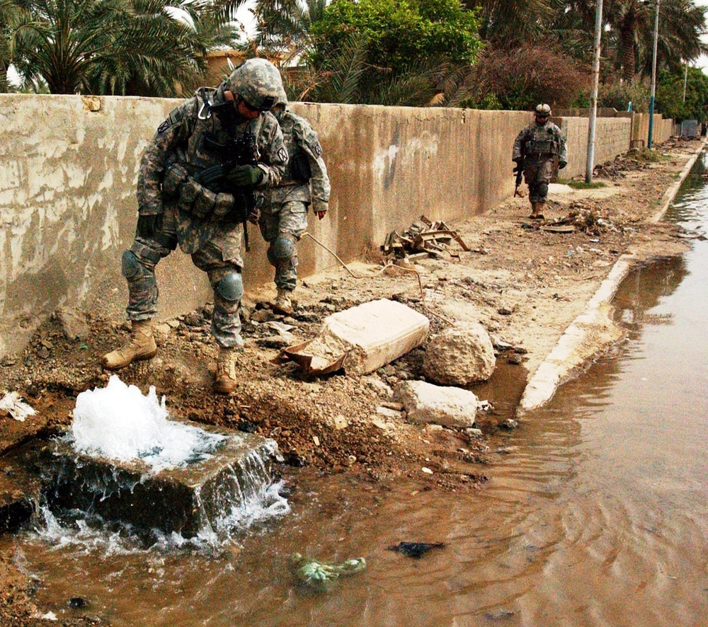 U.S. Army Officer Inspects Water Main Break in Baghdad Neighborhood