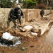 U.S. Army Officer Inspects Water Main Break in Baghdad Neighborhood