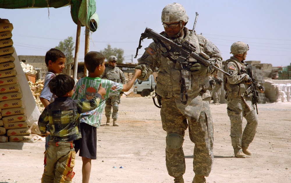U.S. Soldier Connects with Iraqi Boy During Patrol in Sadr City