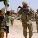 U.S. Soldier Connects with Iraqi Boy During Patrol in Sadr City