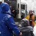 Volunteer Helps Disabled Veterans Board Bus for Winter Sports Clinic