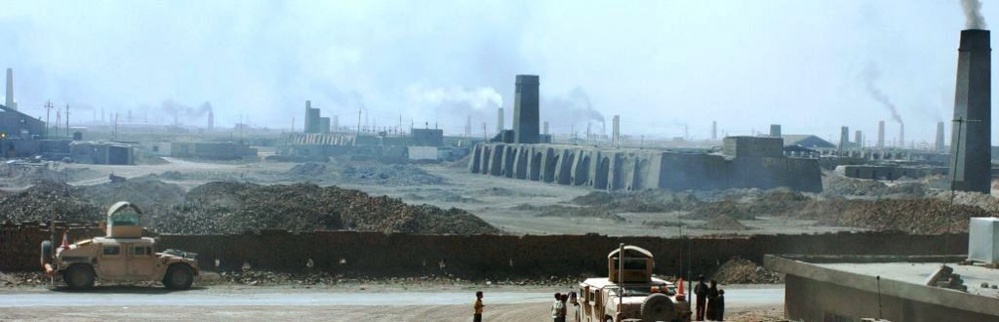 Humvees Guard Entrance to Bustling Brick Factory in Iraq