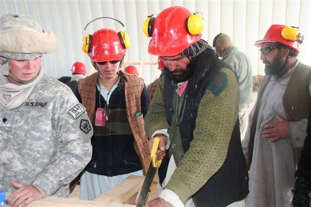 U.S. Soldier Teaches Afghan Men Carpentry Skills at Forward Operating Base