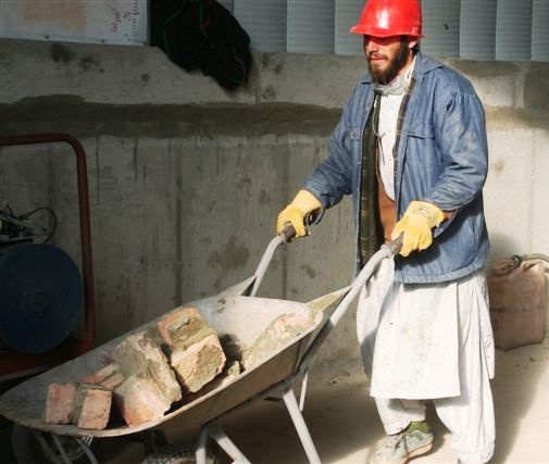 Afghan Man Cleans Up After Skilled-Labor Workshop at Forward Operating Base