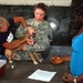 Volunteers Administer Deworming Medication to Protect Puppy and People