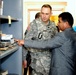 University Dean Shows Damage from Rocket Attack to U.S. Military Official