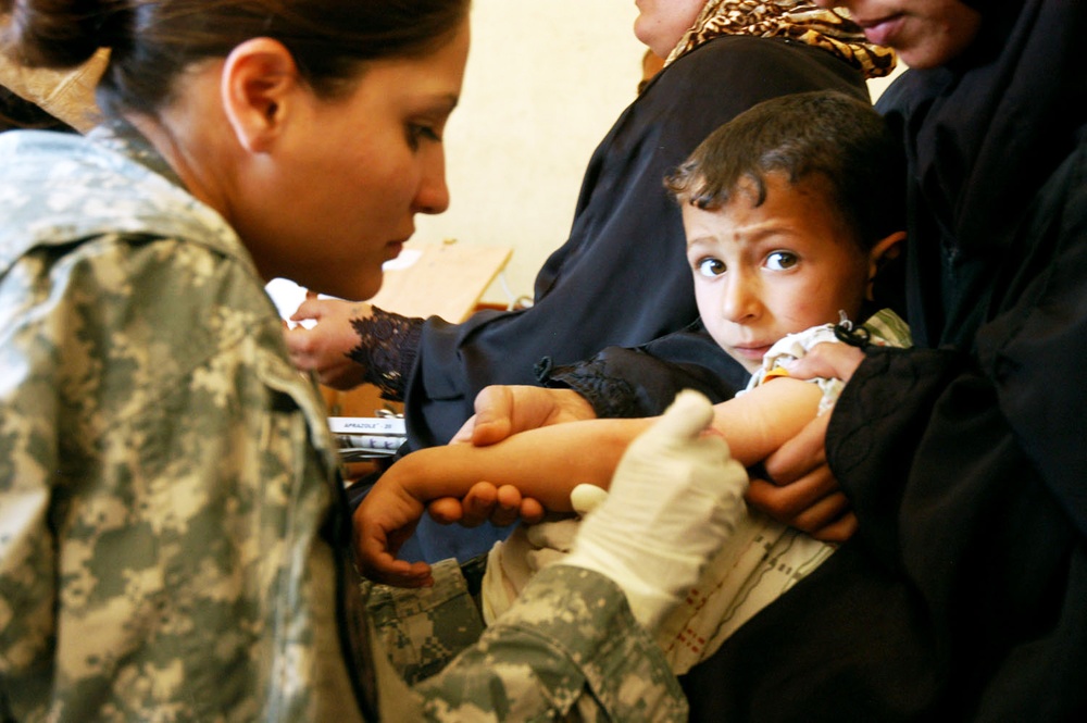 Army Medic Treats Injured Child in Iraq