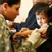 Army Medic Treats Injured Child in Iraq