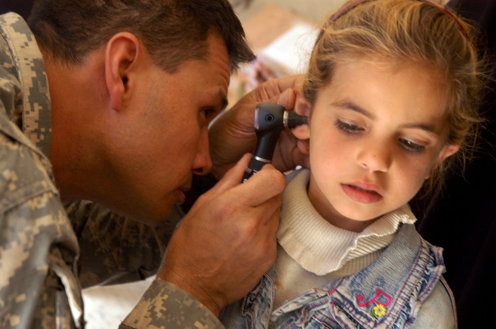 Army Medic Provides Care to Iraqi Girl During Combined Mission