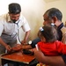 Iraqi Doctor Checks Patient's Blood Pressure in Bata Village