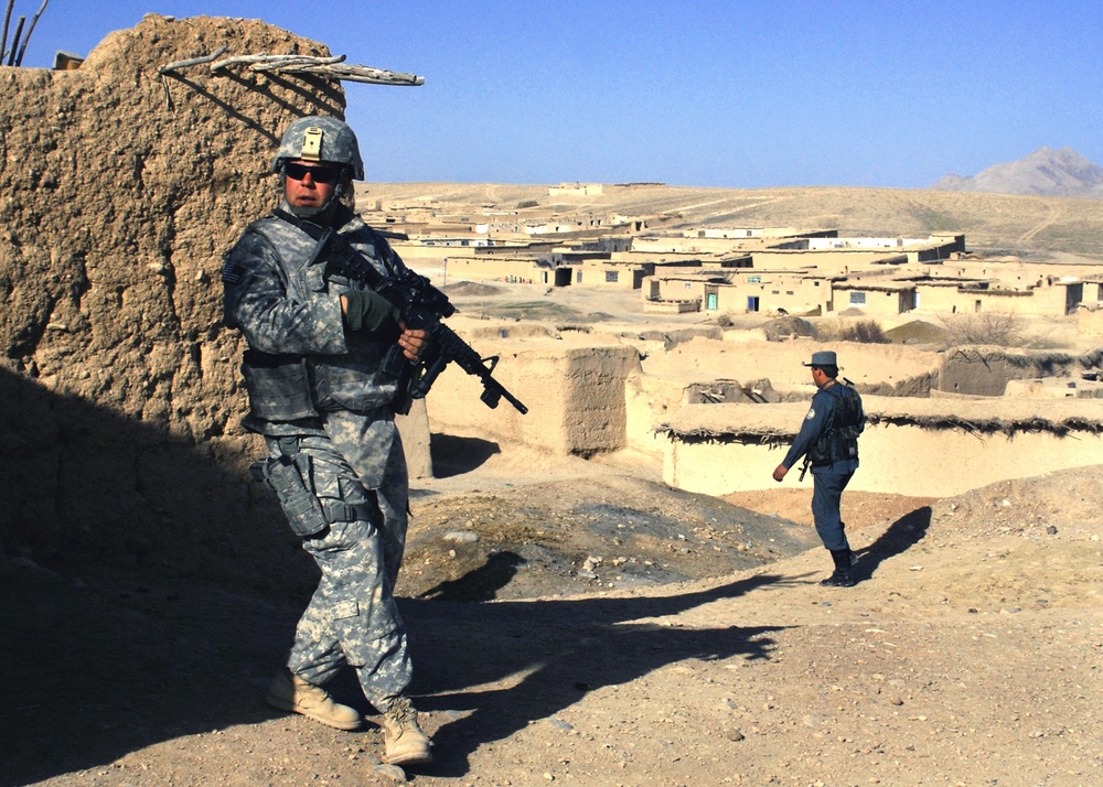 U.S. Soldier Provides Security for Afghan Police Patrol in Afghanistan