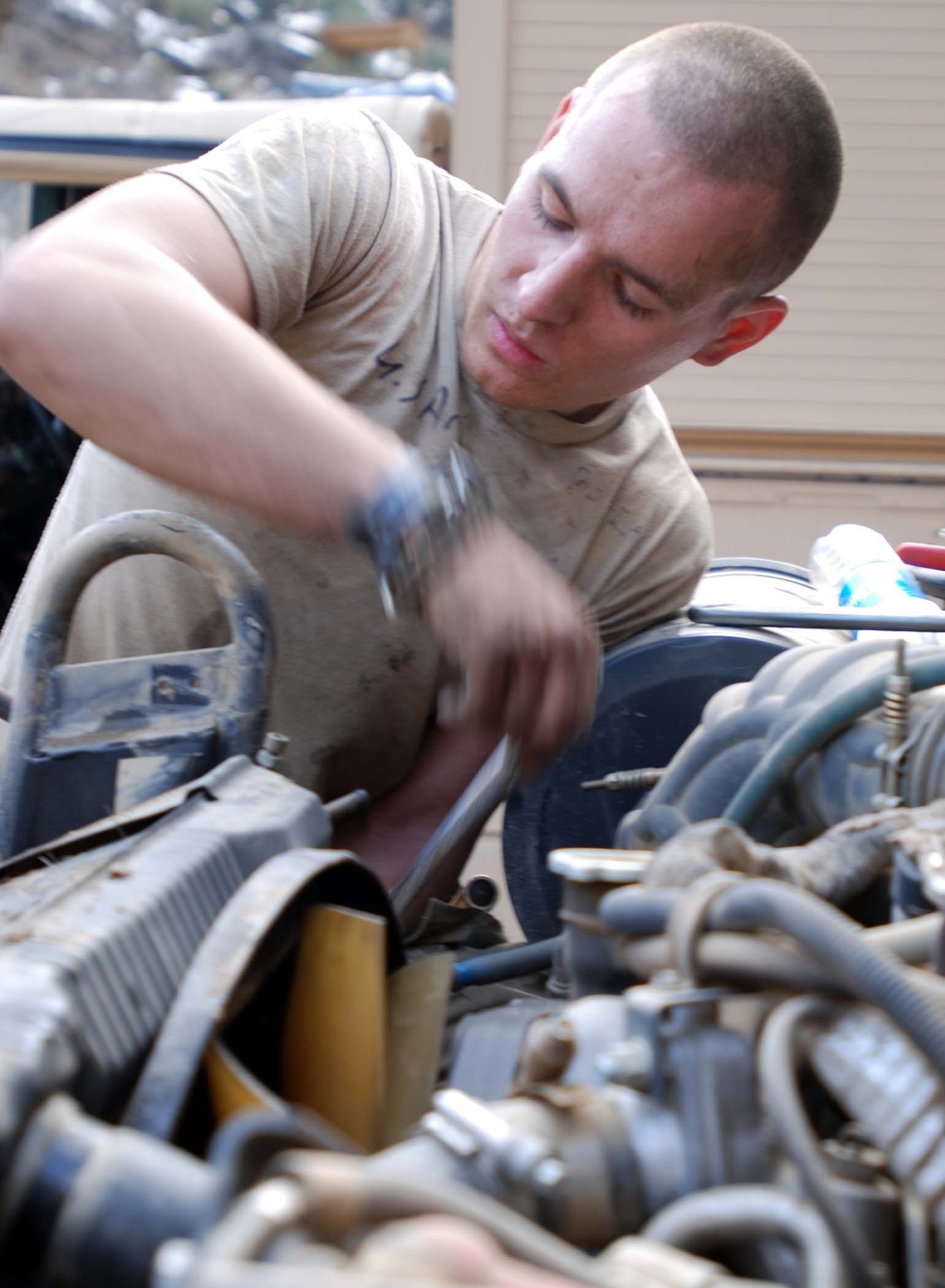 Army Mechanic Repairs Radiator at Forward Operating Base in Afghanistan