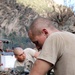 Army Mechanics Repair Damage from Rocket Attack in Afghanistan