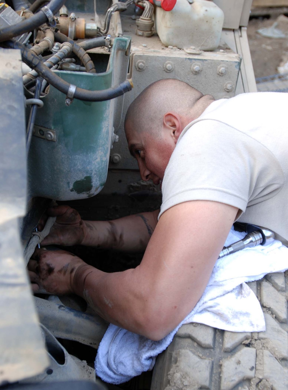 Army Mechanic Repairs Damaged Radiator at Forward Operating Base in Afghanistan