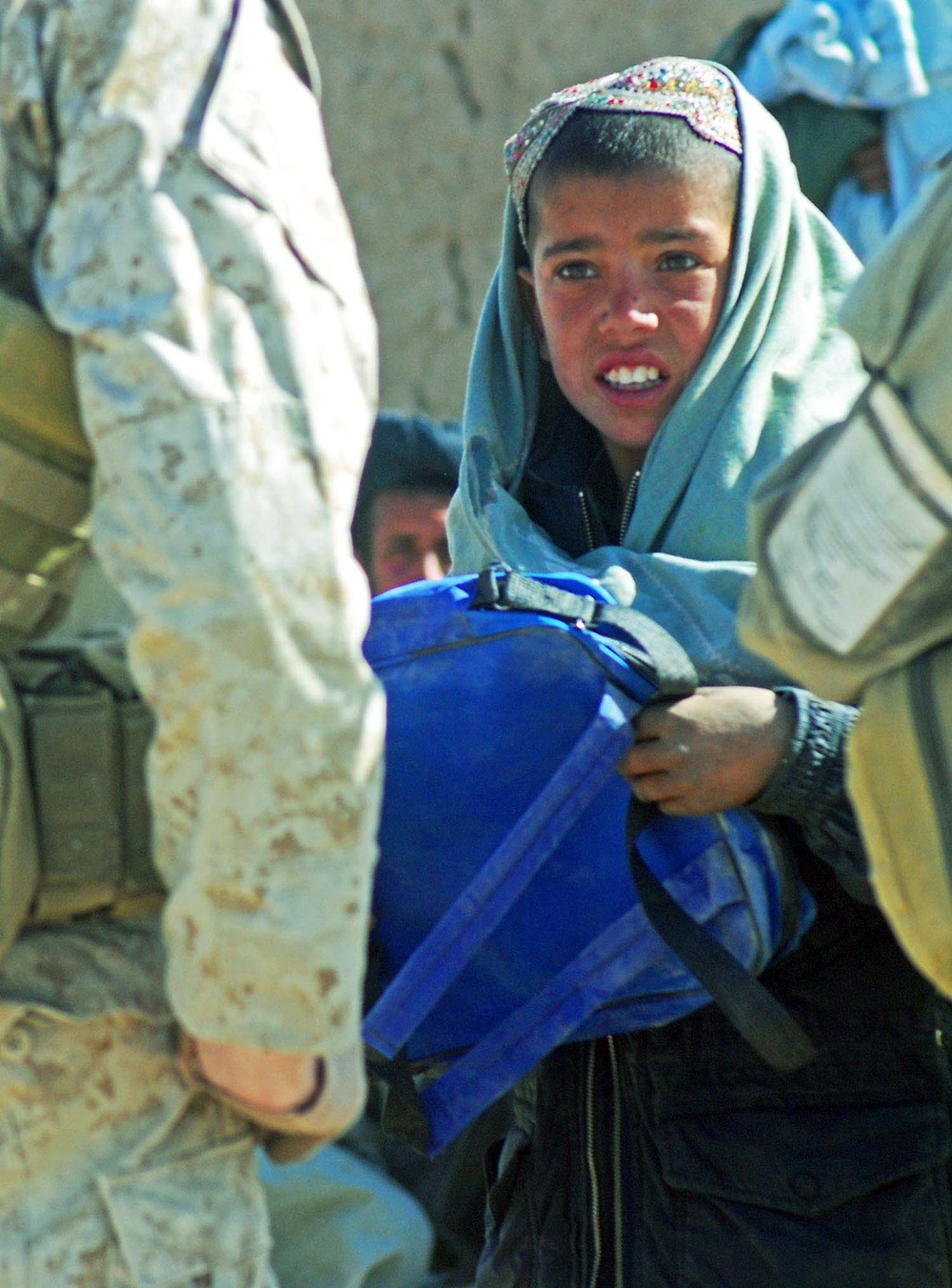 Afghan Boy Receives School Bag from U.S. and Afghan Forces