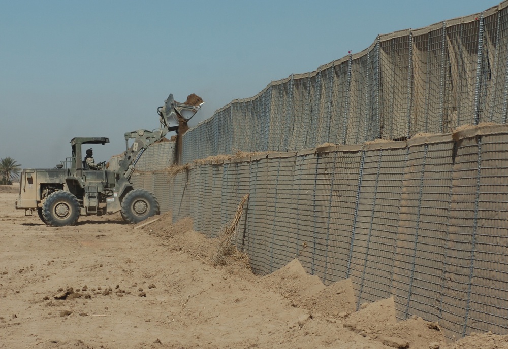 Soldier Operates Front-End Loader to Fill Hesco Barriers at Patrol Base Vanderhorn