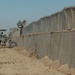 Soldier Operates Front-End Loader to Fill Hesco Barriers at Patrol Base Vanderhorn