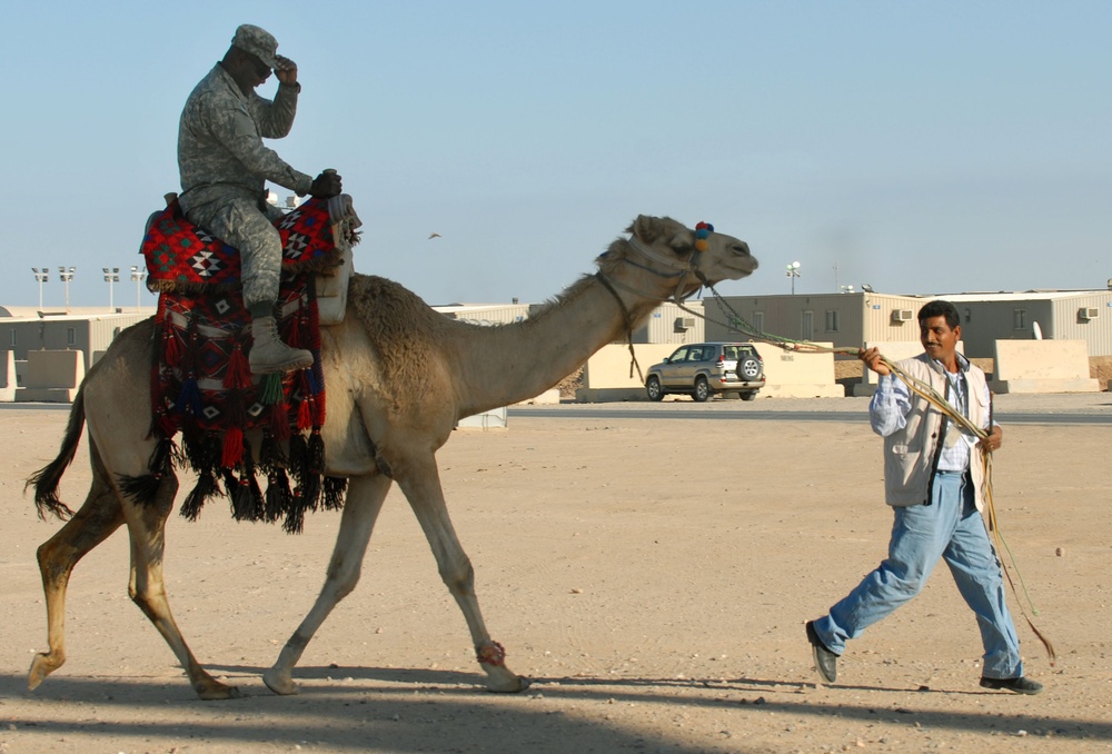 Soldier Enjoys Camel Ride at Kuwait Base