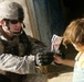 U.S. Soldier Teaches Iraqi Child to Make Paper Airplane in Mosul
