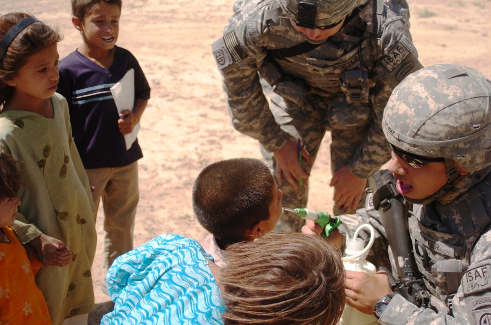 Army Medic Provides Medical Care to Afghan Child During Outreach Event