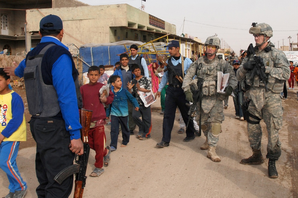 U.S. Soldiers Distribute Newspapers in Iraqi Town