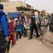 U.S. Soldiers Distribute Newspapers in Iraqi Town
