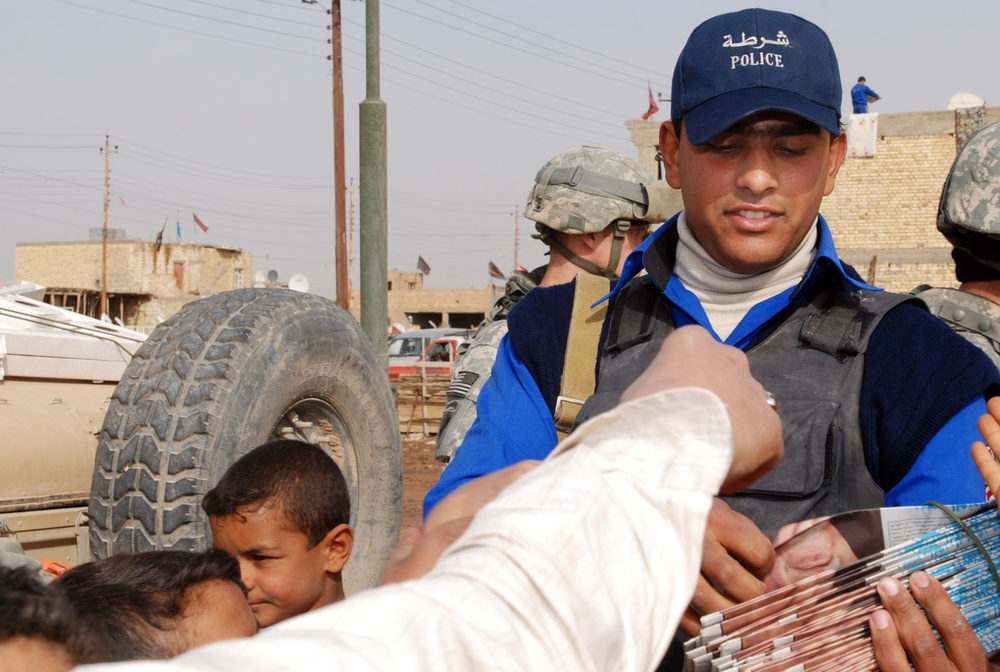 Soldiers and Police Distribute Local Newspaper in Iraq