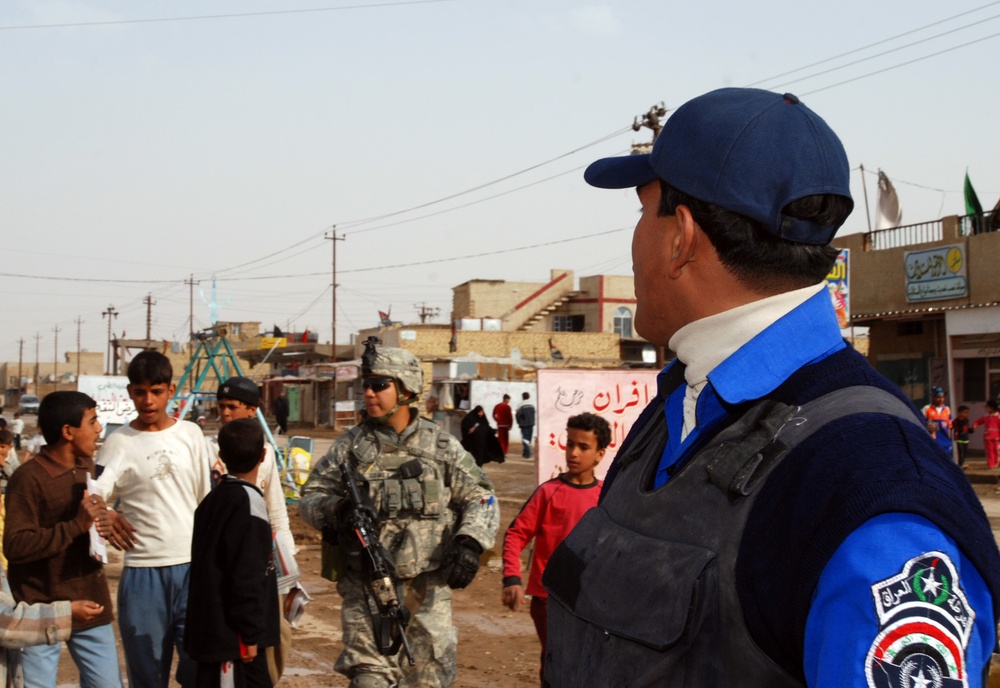 Soldier Connects with Local Children During Joint Patrol in Iraq