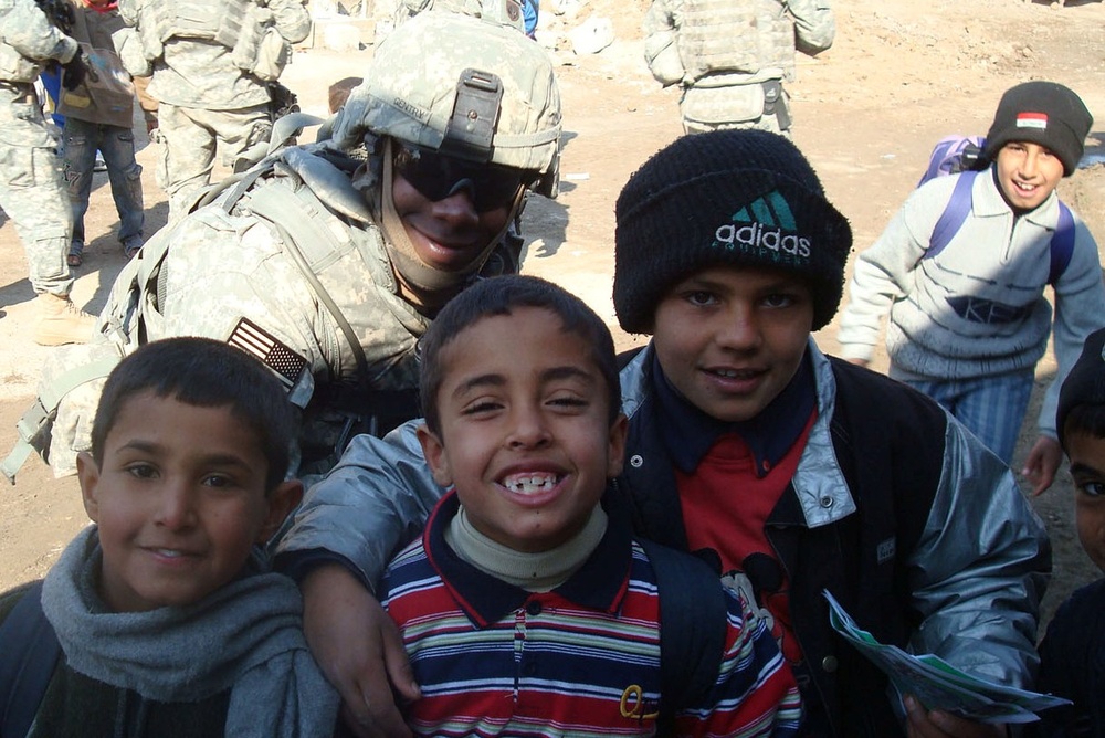 Soldier Connects with Iraqi Children on Patrol