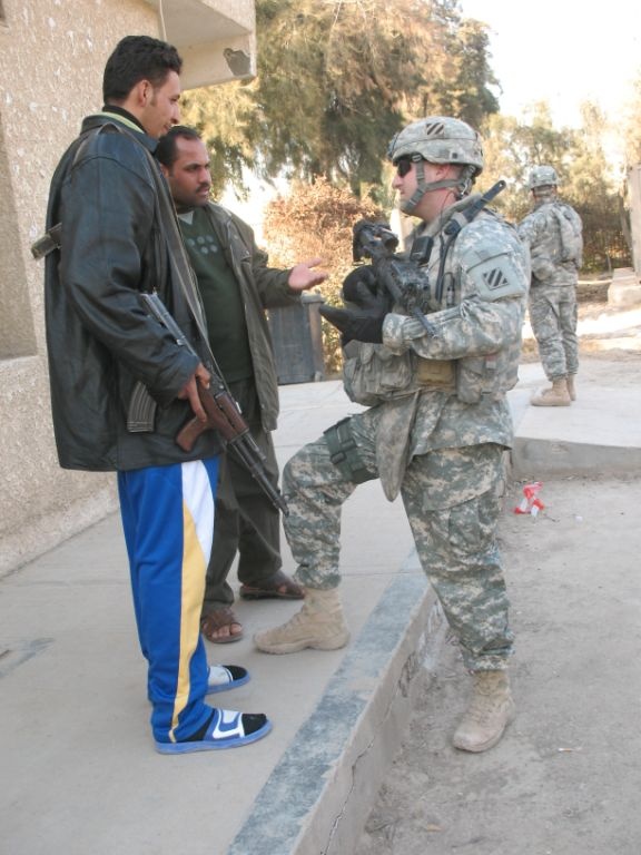 U.S. Soldier Engages with Iraqi Security Group at Hospital in Salman Pak