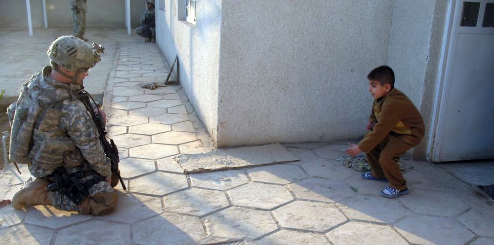 Soldier Plays Marbles with Iraqi Boy During Hospital Visit