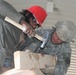 U.S. Soldier Assists Afghan Man in Building Tool Shed at Forward Operating Base