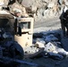 Army Officer Assesses Damaged Vehicle in Afghanistan