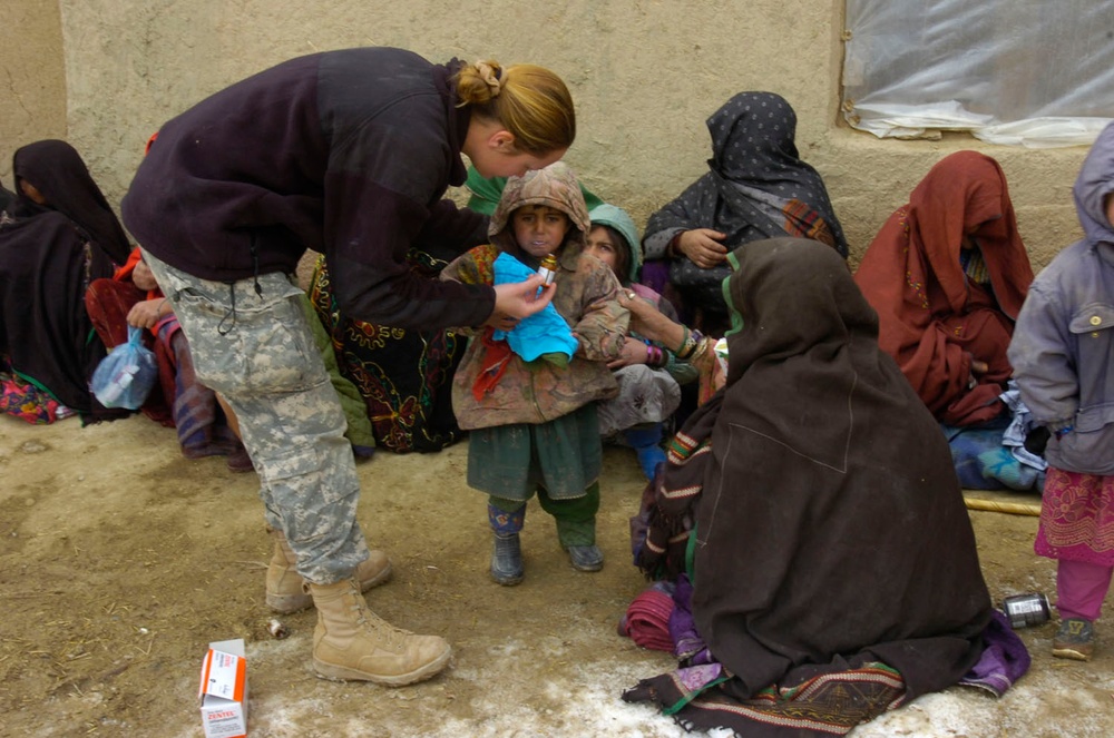 Army Medic Provides Deworming Treatment to Afghan Child
