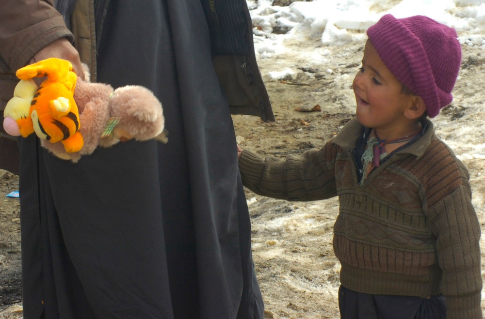 Afghan Boy Receives Stuffed Animals from Security Forces