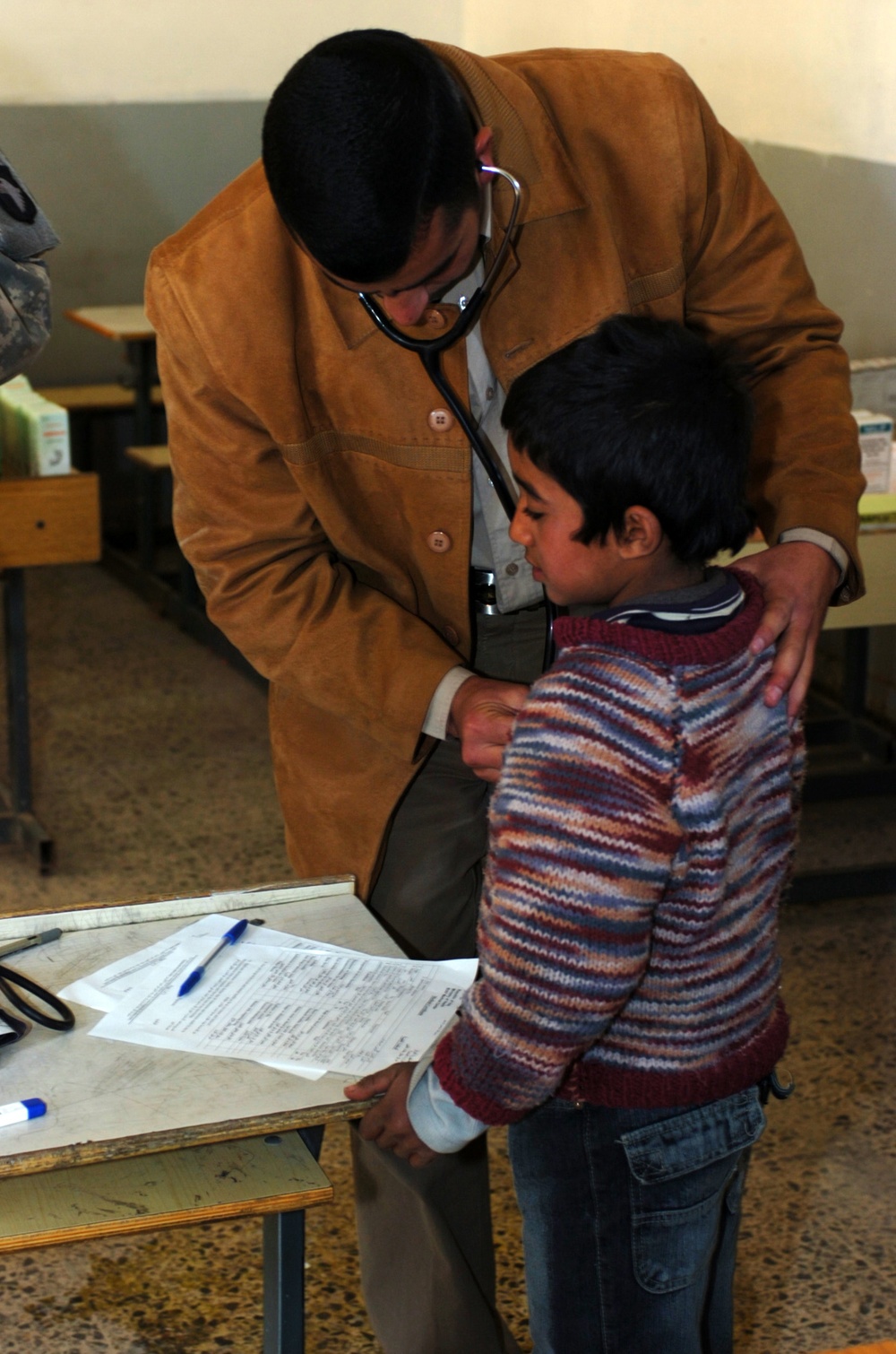 Iraqi Doctor Provides Medical Care to Boy at Baghdad School