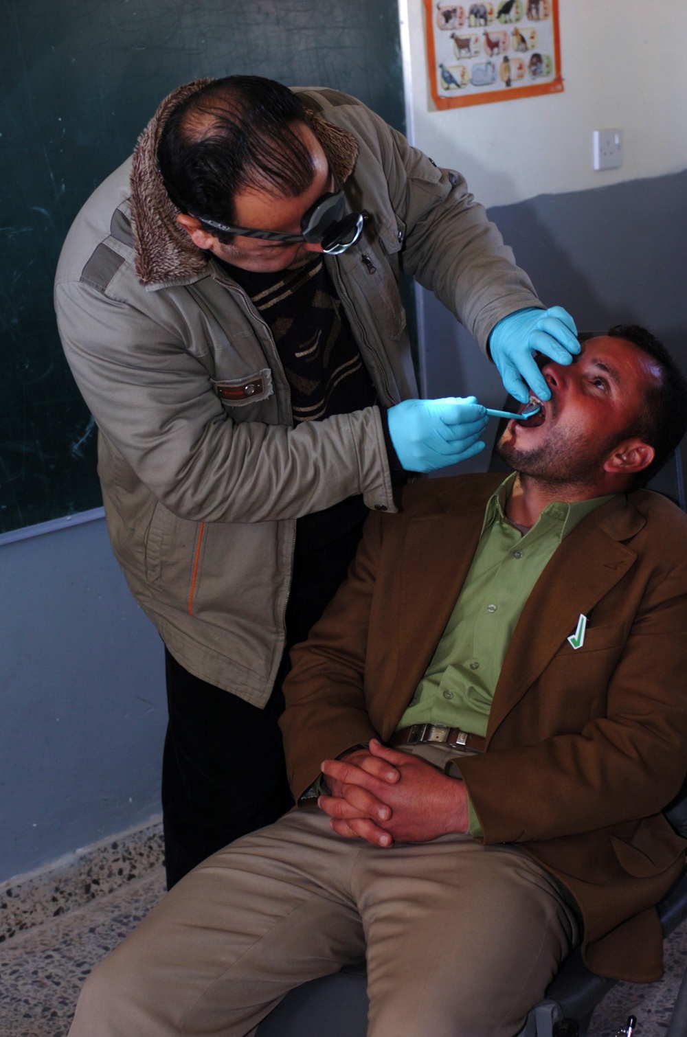 Iraqi Dentist Provides Dental Care to Child at Baghdad School