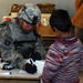 Army Medic Provides Health Assessment for Iraqi Boy During Medical Operation