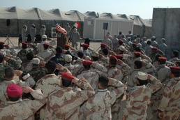Trainees Salute Iraqi Flag at Welcoming Ceremony for New NCO Academy