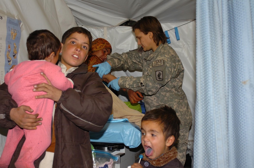 U.S. Army Medic Provides Care to Afghan Mother at FOB Naray Aid Station