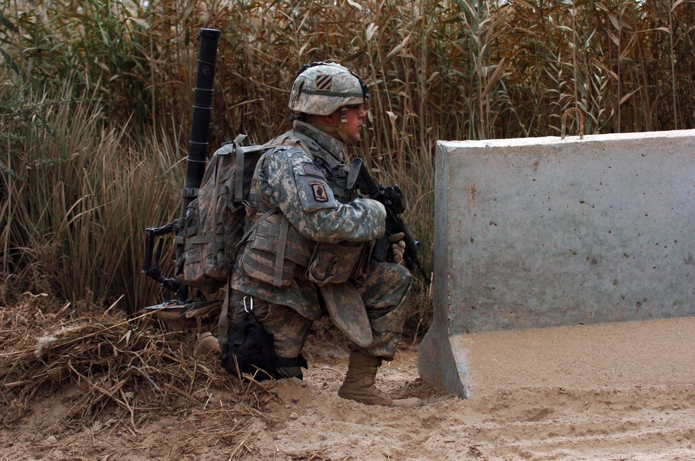 Soldier Seeks Cover After Sniper Attack in Iraq