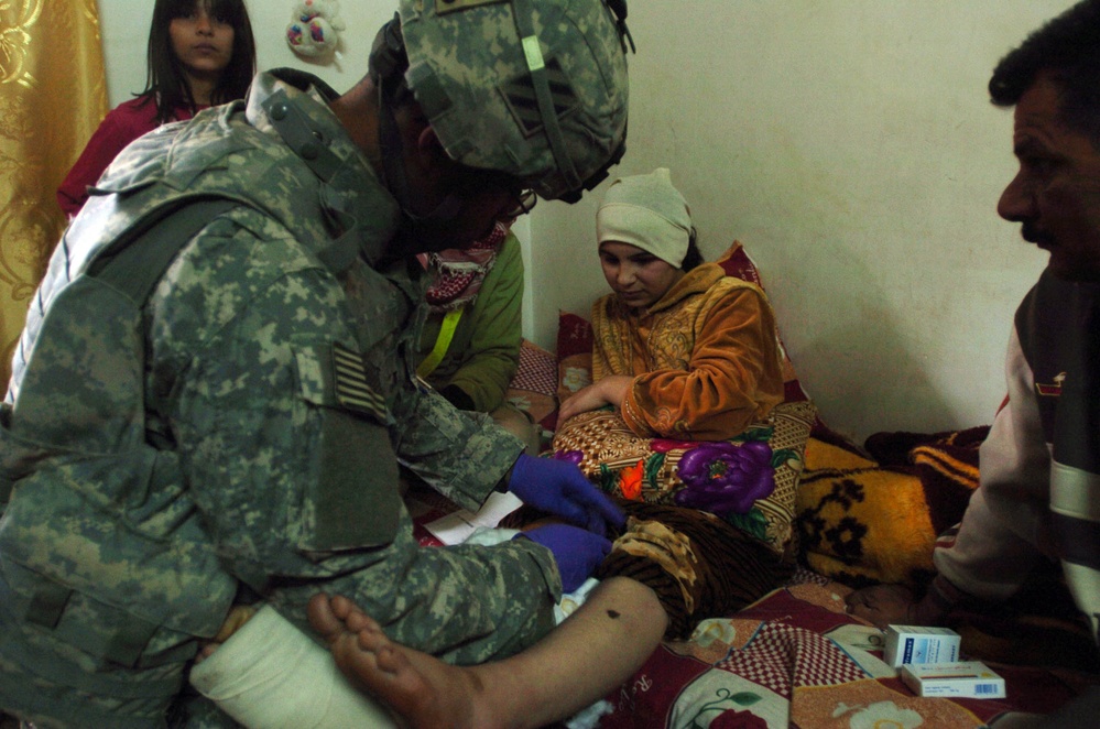 Army Medic Treats Injured Iraqi Girl After Mortar Attack